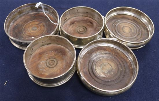 A pair of modern plain silver wine coasters, a similar smaller pair of wine coasters and a pierced example